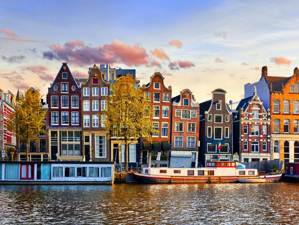 Amsterdam Netherlands dancing houses over river Amstel landmark in old european city spring landscape.