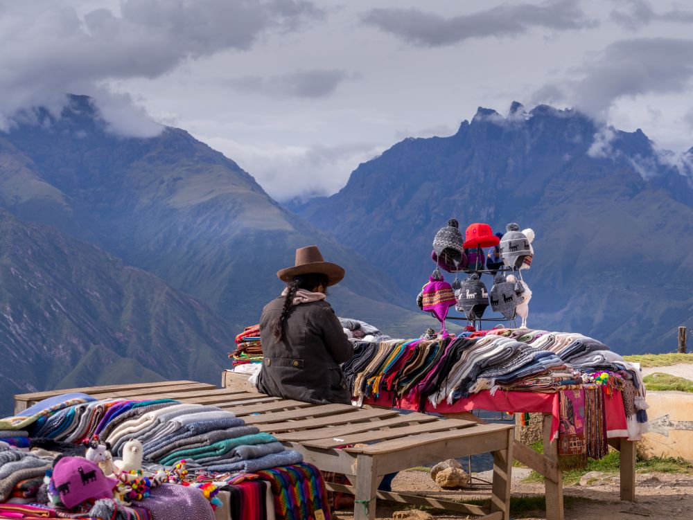 Peruvian women selling colorful hats and scarfs on the scenic and popular viewpoint.