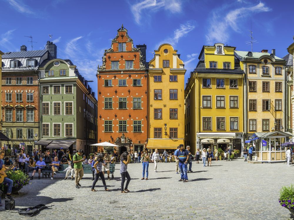 Stockholm Stortorget tourists in medieval square colourful houses restaurants Sweden
