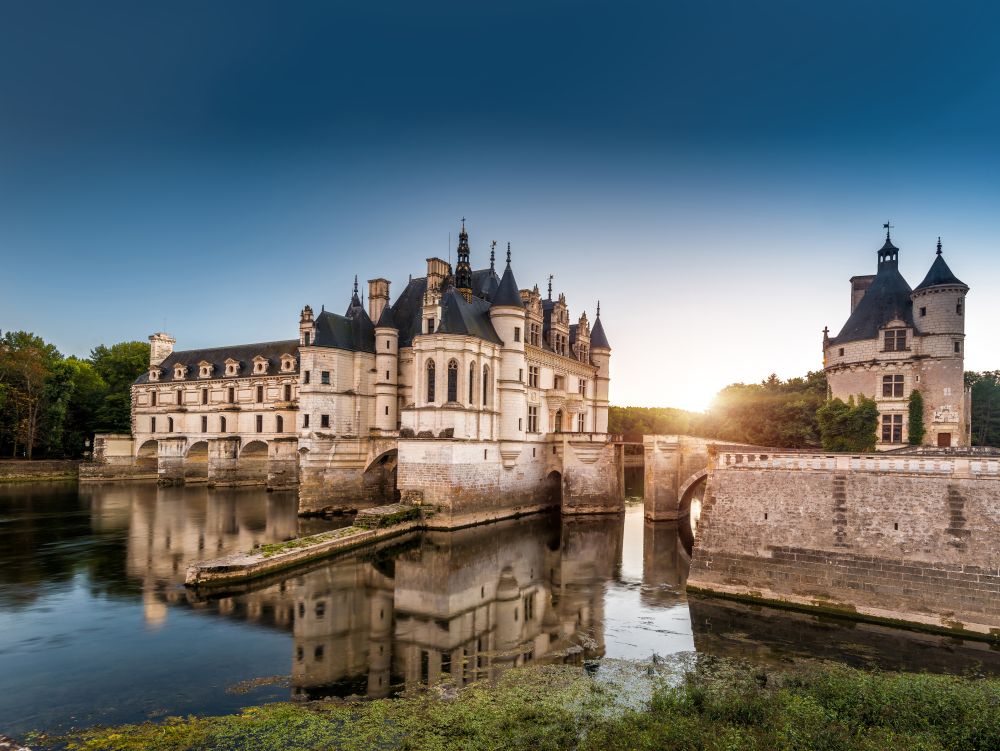 The Chateau de Chenonceau at sunset, France. This castle is located near the small village of Chenonceaux in the Loire Valley, was built in the 15-16 centuries and is a tourist attraction.