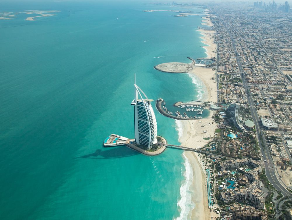 Aerial view of Dubai city beach and coast line on a clear sunny day.