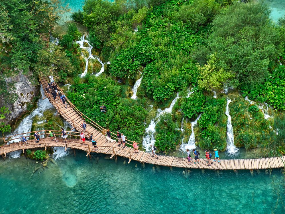 PLITVICE, CROATIA - JULY 29: Tourist enjoy sightseeing the lakes and wonderful landscapes at the Plitvice natural Park in Croatia during the summer holidays, on July 29th, 2016 in Plitvice, Croatia