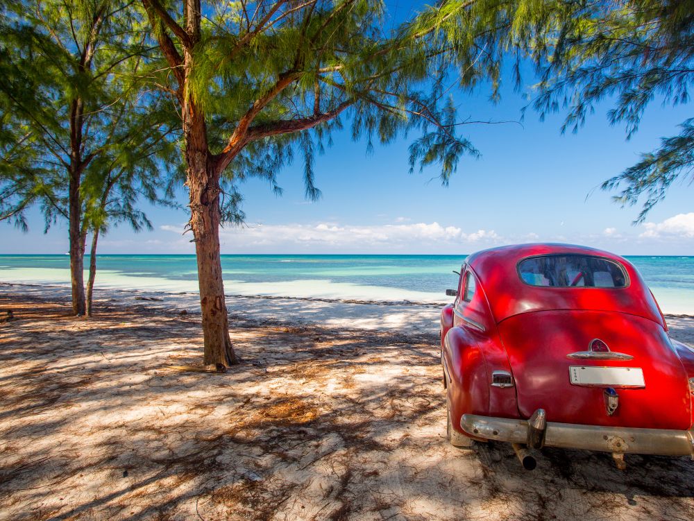 Classic car on a beach in Cuba